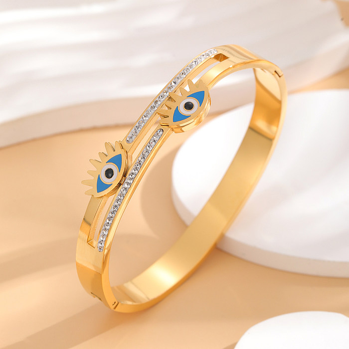 Brazalete chapado en oro de diamantes de imitación con incrustaciones de epoxi de acero de titanio con ojo artístico