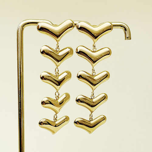 1 paire de boucles d'oreilles pendantes en forme de cœur exagérée, en acier inoxydable, avec pompon en métal plaqué or
