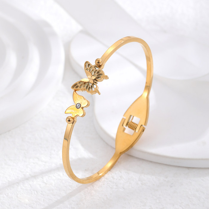Brazalete chapado en oro de titanio de acero de titanio con mariposa redonda retro al por mayor de diamantes de imitación