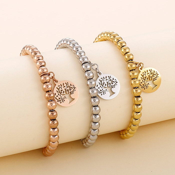 Elegantes pulseras chapadas en oro de acero titanio con árbol de girasol