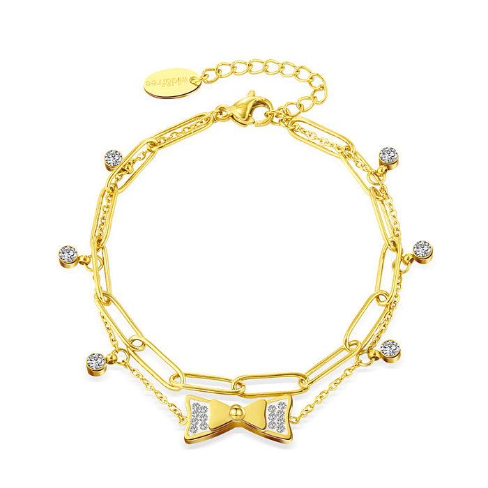 Bracelet en acier au titane plaqué or 14 carats avec pendentif en forme d'arc incrusté de zircons à la mode