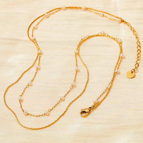 Elegante, mehrschichtige Halsketten mit geometrischen Edelstahlbeschichtungen und künstlichen Perlen