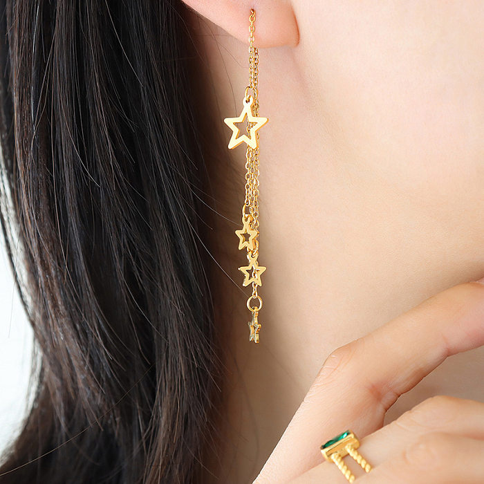 1 paire de boucles d'oreilles pendantes plaquées en acier inoxydable avec pompon étoile à la mode