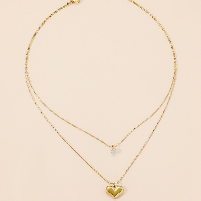Elegante, glänzende herzförmige Edelstahl-Halskette mit polierter Beschichtung und Inlay aus Zirkon mit 18-Karat-Vergoldung