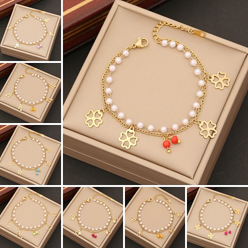 Bracelets de placage en couches de perles artificielles en acier inoxydable, croix de trajet de Style Simple, fleur de trèfle à quatre feuilles