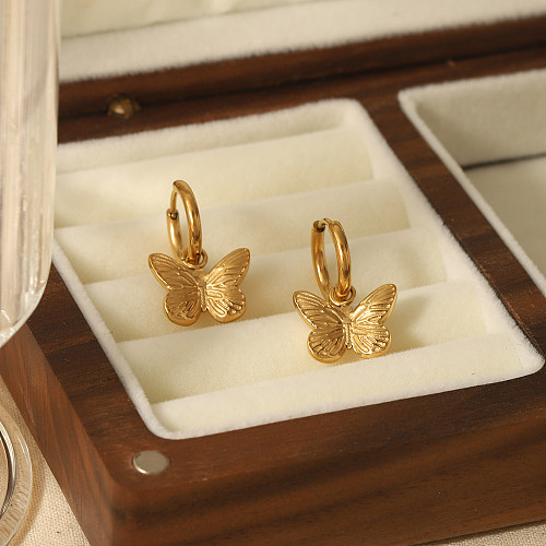 1 par de pendientes colgantes chapados en oro de 18 quilates de acero inoxidable con pulido de mariposa de estilo simple