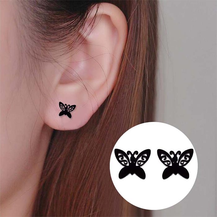 1 paire de clous d'oreilles papillon tendance en acier inoxydable.