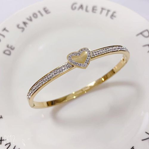 Brazalete de diamantes de imitación con incrustaciones de pulido de acero de titanio y ojo en forma de corazón de estilo vintage