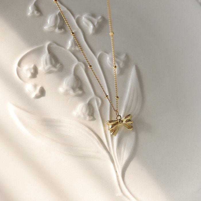 Collier pendentif plaqué or 18 carats en acier inoxydable avec nœud papillon doux
