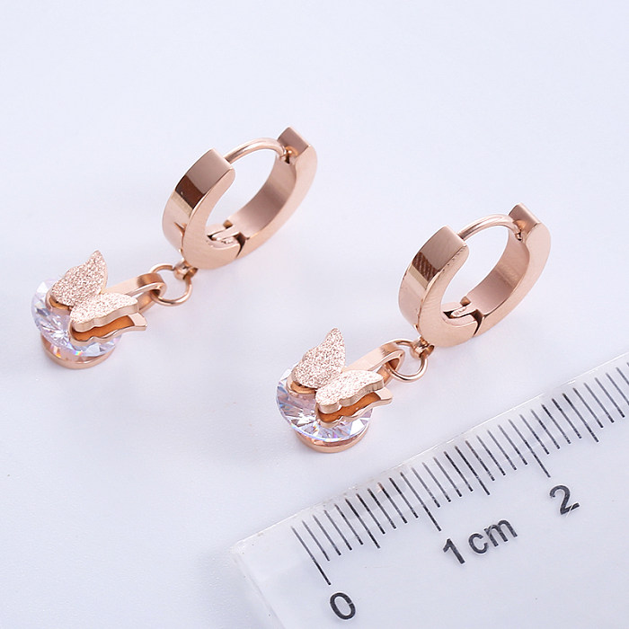 1 paire de boucles d'oreilles pendantes décontractées de style simple et classique avec incrustation de papillon en acier inoxydable et zircon plaqué or rose 18 carats.