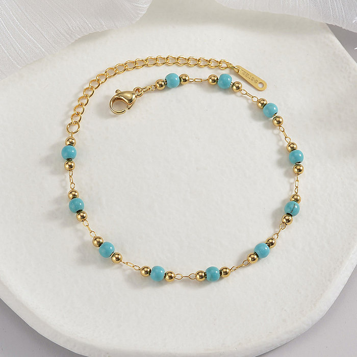 Runde Armbänder im französischen Retro-Stil aus Edelstahl mit türkisfarbener Perlenbeschichtung und 18-Karat-Vergoldung