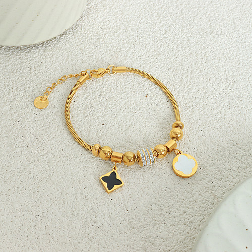 Elegantes e luxuosas pulseiras de zircão banhadas a ouro 18K em aço titânio com trevo de quatro folhas a granel