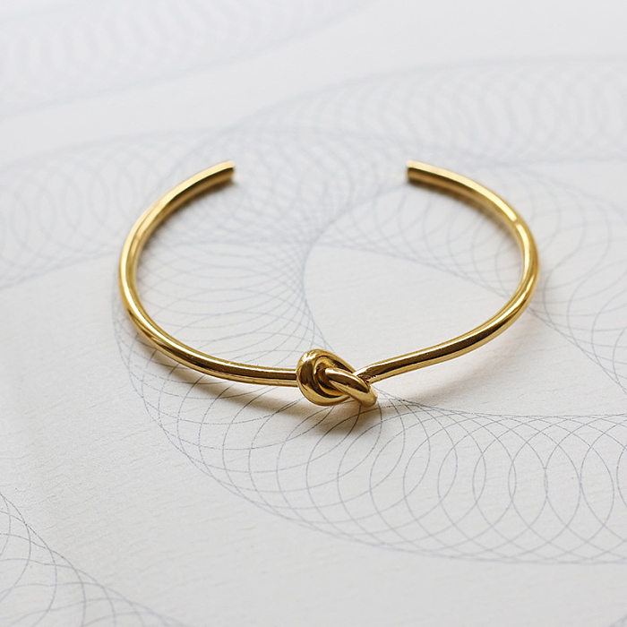 Einfaches geknotetes Titanstahl-Armband mit 18-karätigem Gold. Großhandel für Schmuck