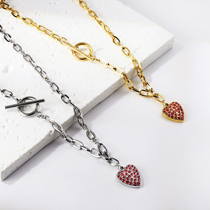 Halskette in Herzform aus Edelstahl im IG-Stil mit Intarsien und Strasssteinen