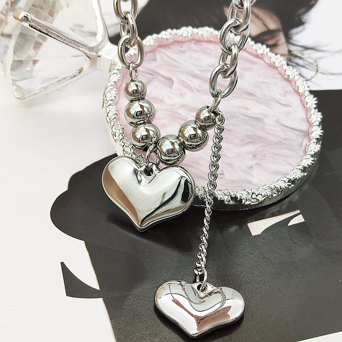 Collier pendentif plaqué en acier inoxydable en forme de cœur pour dame