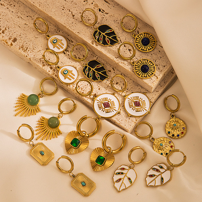 Pendientes colgantes de circonita con incrustaciones chapadas en oro de acero inoxidable con ojo de hojas de sol a la moda, 1 par