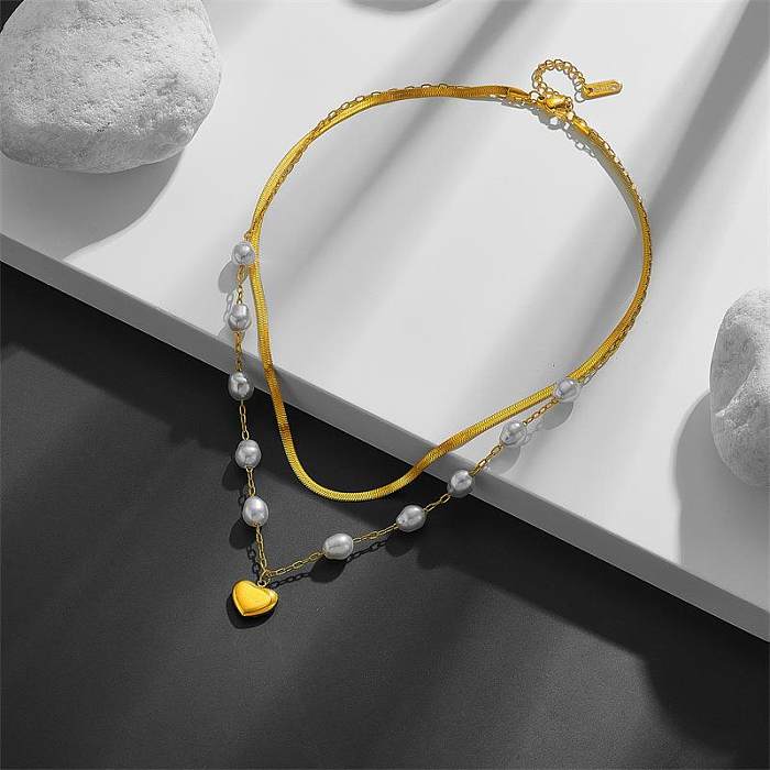 Colliers superposés de perles artificielles avec incrustation de placage en acier inoxydable en forme de cœur doux élégant
