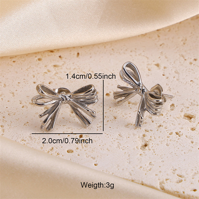 1 paire de clous d'oreilles en acier inoxydable avec nœud papillon de style simple