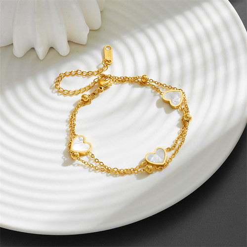 Süße, schlichte, herzförmige Armbänder aus Titanstahl mit Inlay-Shell und 18-Karat-Vergoldung