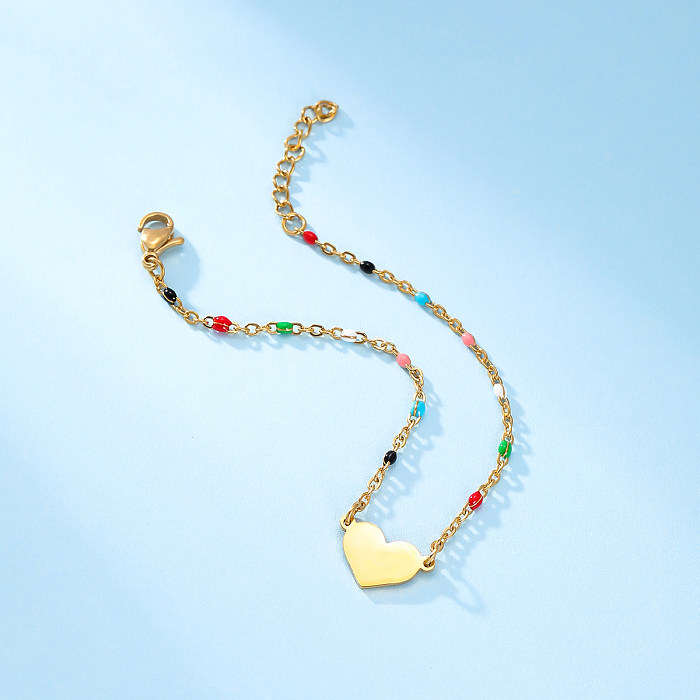 Commute Kreuzherzförmige Armbänder aus Edelstahl mit Perlenbeschichtung und 18-Karat-Vergoldung