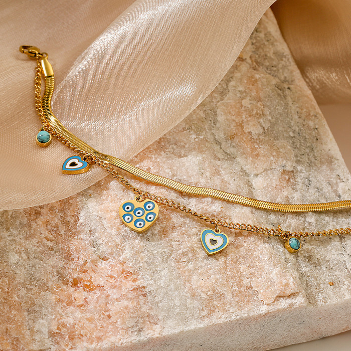 Bracelets plaqués or 18 carats avec incrustation de placage en acier titane en forme de cœur œil du diable de style simple