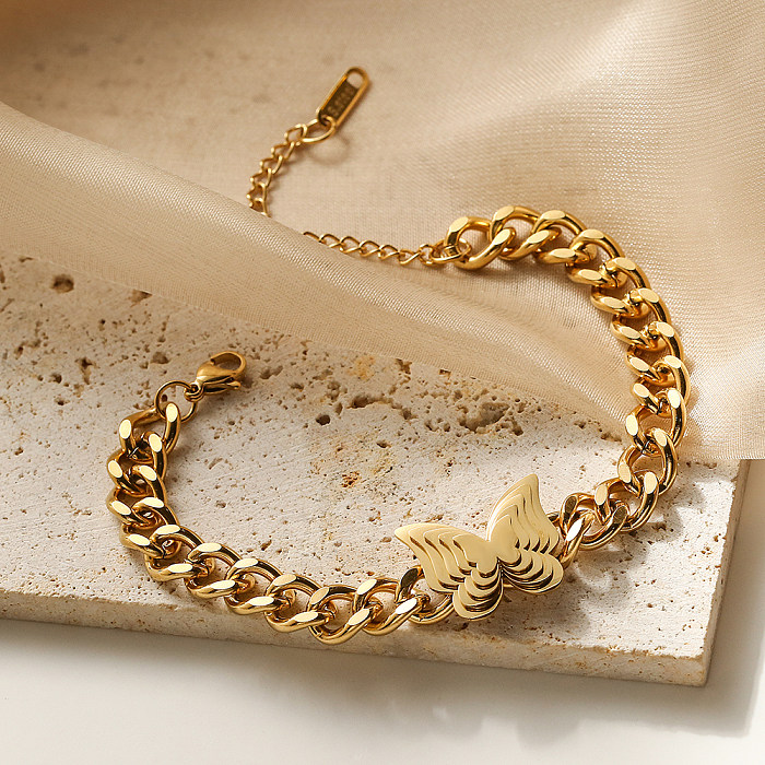 O estilo simples comuta braceletes chapeados ouro do chapeamento de aço 18K do titânio da borboleta