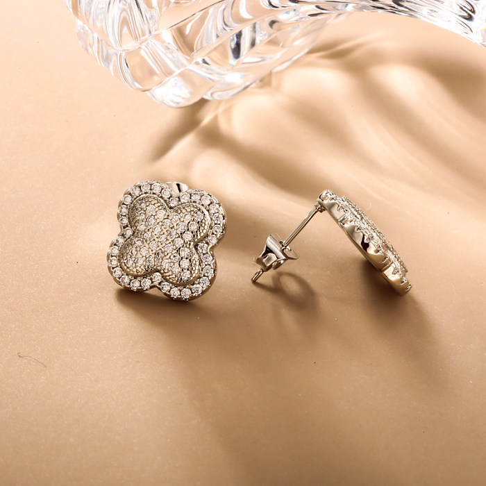 Brass clover inlaid zircon ear buckle