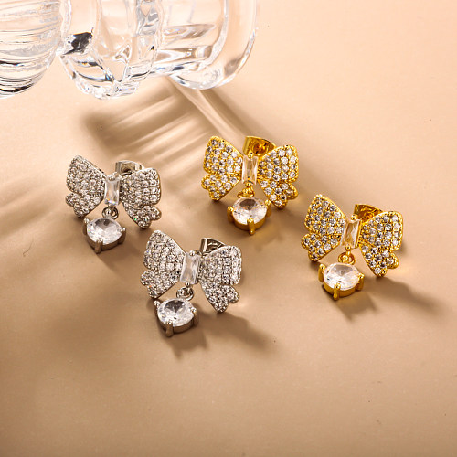 Brass bow with zircon earrings embedded