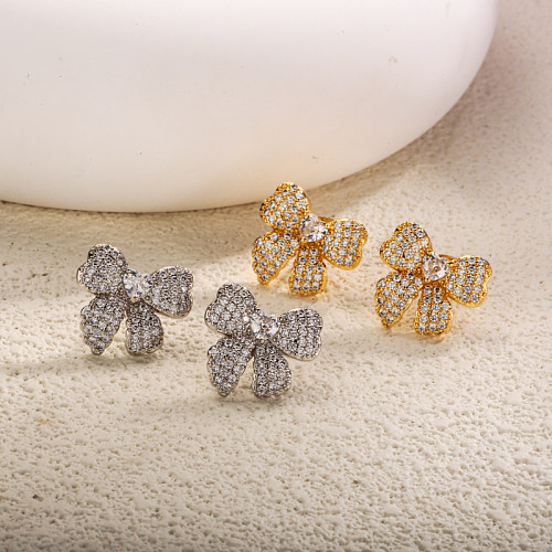 Brass bow with zircon earrings embedded
