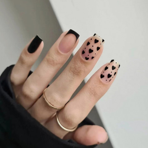 Wearing French style nail art, wearing black edged black heart-shaped nail patches, wearing fake nails