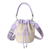 Cross border Grass Woven Bucket Bag for Women's Autumn Fashion Drawstring Handheld Shoulder Bag with Western Style and Personalized Crossbody Bag Bags