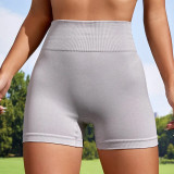 Seamless knitted yoga shorts from Europe and America, peach lifting buttocks, high waist fitness pants, tight fitting running sports, three part women's shorts