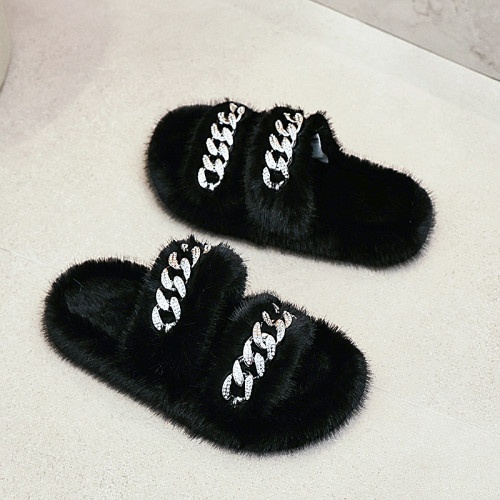 Wearing thick soled mink fur slippers on top of fur shoes for home use