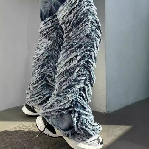 Washed denim jeans with worn edges and holes
