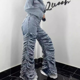 Washed denim jeans with worn edges and holes