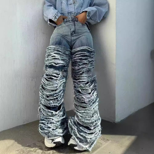 Washed denim jeans with worn edges and holes