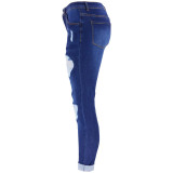 Women's jeans with holes and small feet