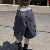 Workwear style with multiple pockets, cuffed and tied up half length pants, loose and casual low waisted straight woven shorts