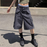 Workwear style with multiple pockets, cuffed and tied up half length pants, loose and casual low waisted straight woven shorts