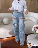 Washed denim jeans with multiple pockets and hand drilled openings