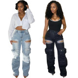 Washed denim jeans with multiple pockets and hand drilled openings