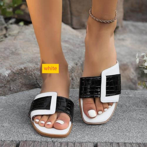 Wearing square shaped stone patterned oversized slippers outside