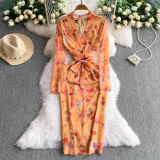 Long sleeved V-neck lace up mid length hip print dress