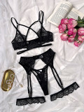 Four-piece lingerie set featuring lace-up steel cups, criss-cross lace, and cut-out design