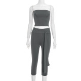 Camisole crop top with exposed navel, high waist, tied ribbon, and seven-inch pants set