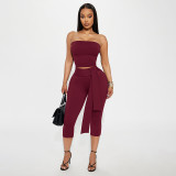 Camisole crop top with exposed navel, high waist, tied ribbon, and seven-inch pants set