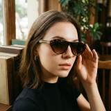 Lifestyle Shot of Female Model Wearing Vintage Tortoise Bold Sunglasses - Chic Library Aesthetic