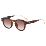 Tortoiseshell retro browline clubmaster sunglasses with pink gradient lenses and gold-tone metal temples, three-quarter view