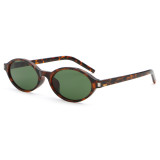 Tortoiseshell oval sunglasses with green lenses