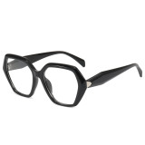 oversized glossy black hexagonal acetate eyeglasses with clear lenses and a silver triangular metal accent at the hinges